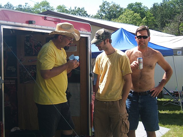 Razzo shows Cody the secrets of shop towel "Origami".  Kerry looks on in amazement.
